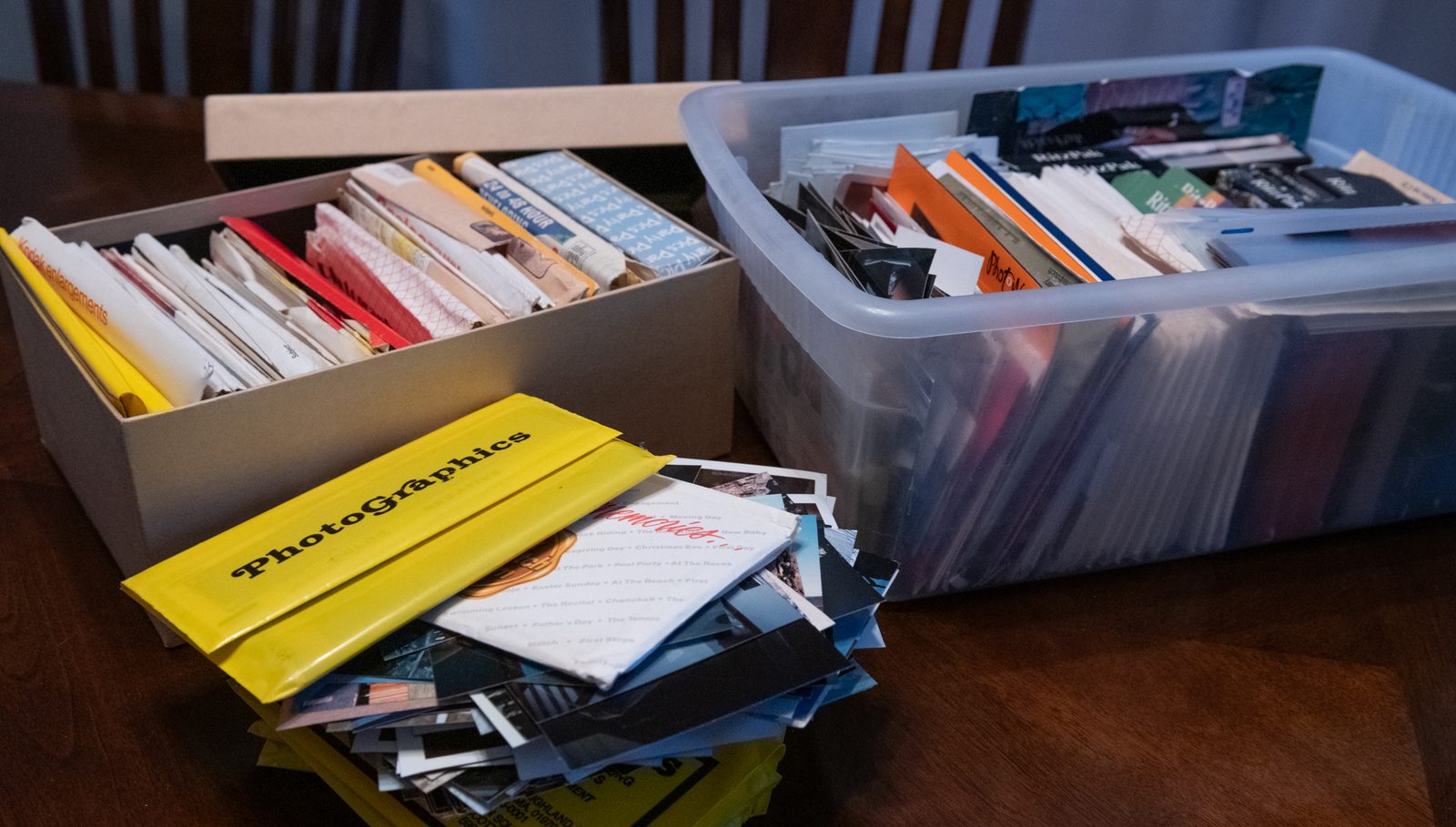 Photo storage boxes and envelopes of prints and negatives ready for scanning